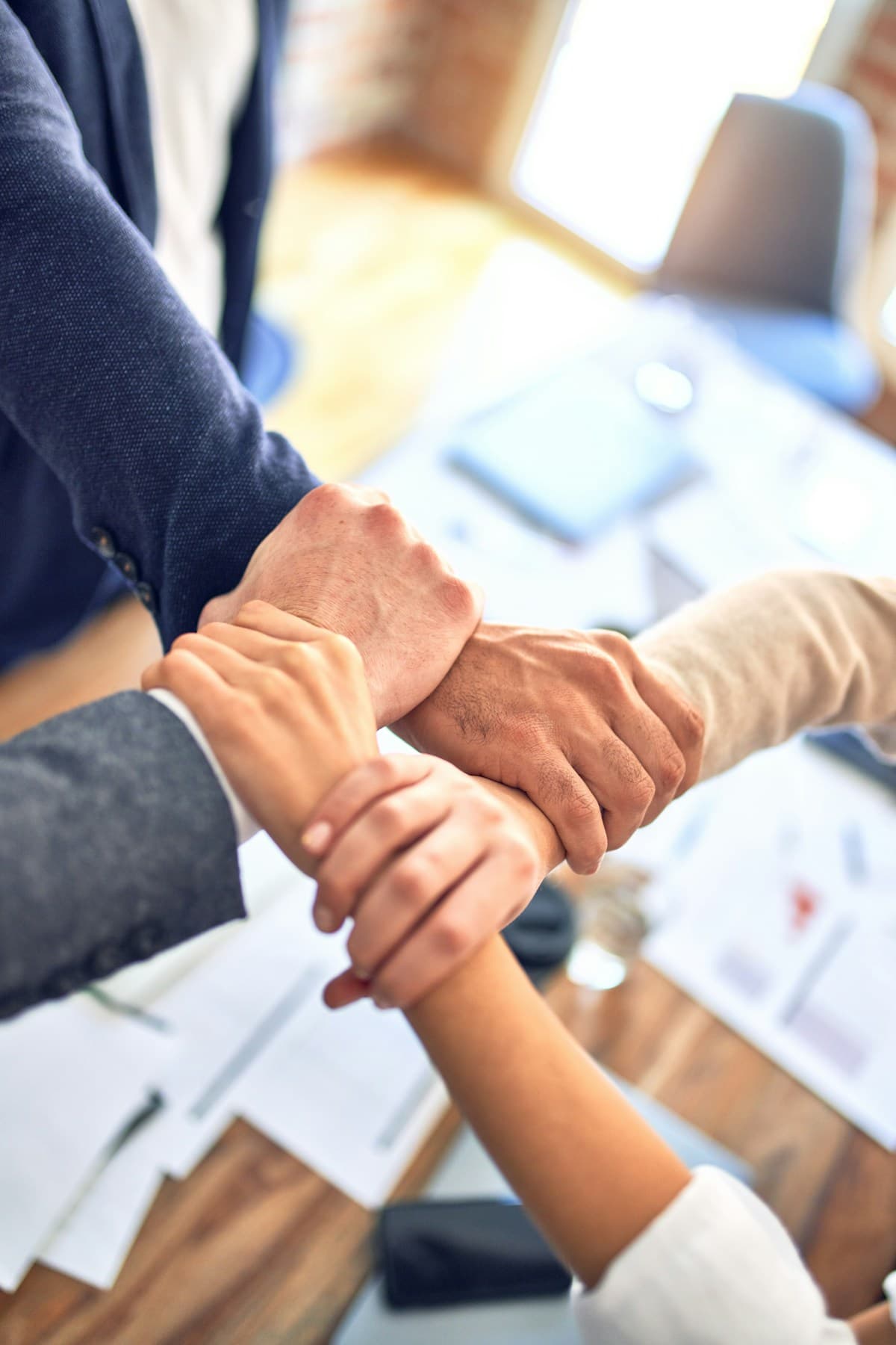 A coach holding a person's hand in a supportive gesture