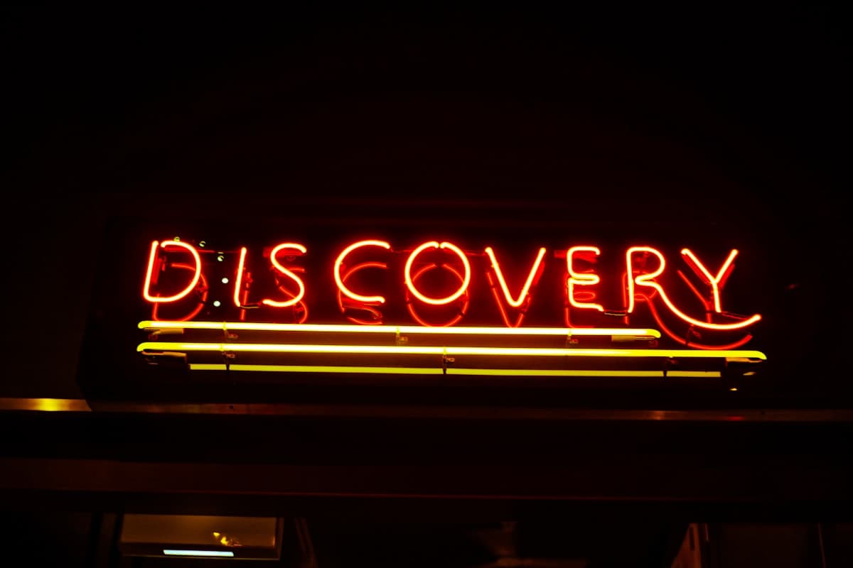 Product discovery whiteboard with sticky notes and laptops